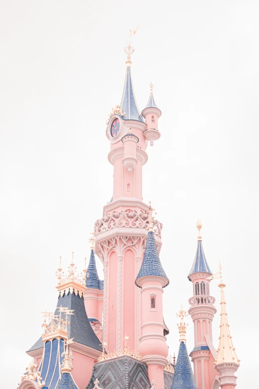 pink and blue castle with a clock on top