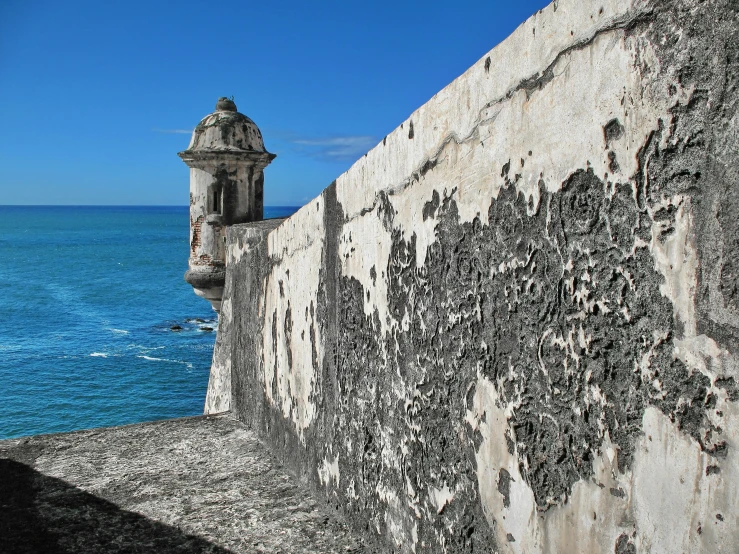 some water and a wall with some graffiti on it