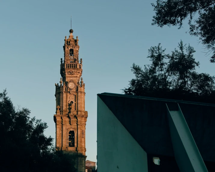 there is a tower in front of some trees