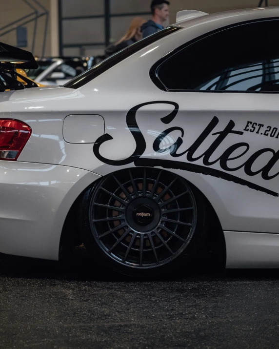 a white car with some black lettering on it