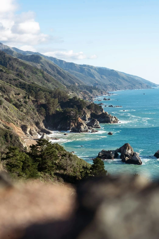 a picture taken from the side of a cliff overlooking a body of water