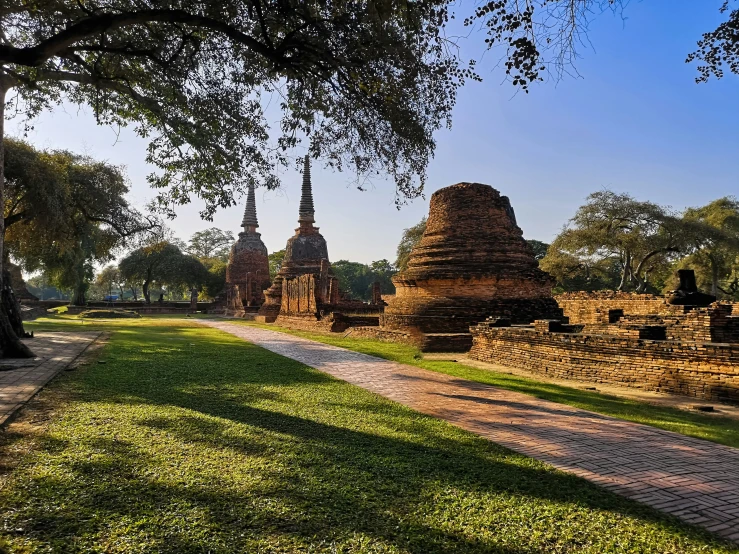 the park with stone statues next to a river