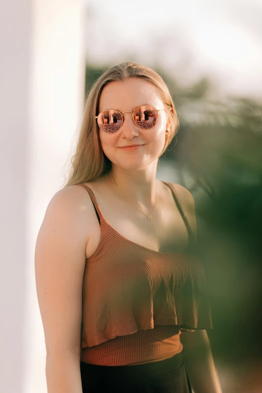 a girl wearing sunglasses posing for a picture