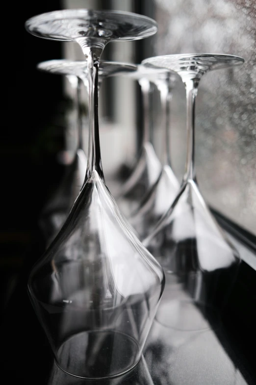 some wine glasses are lined up next to each other