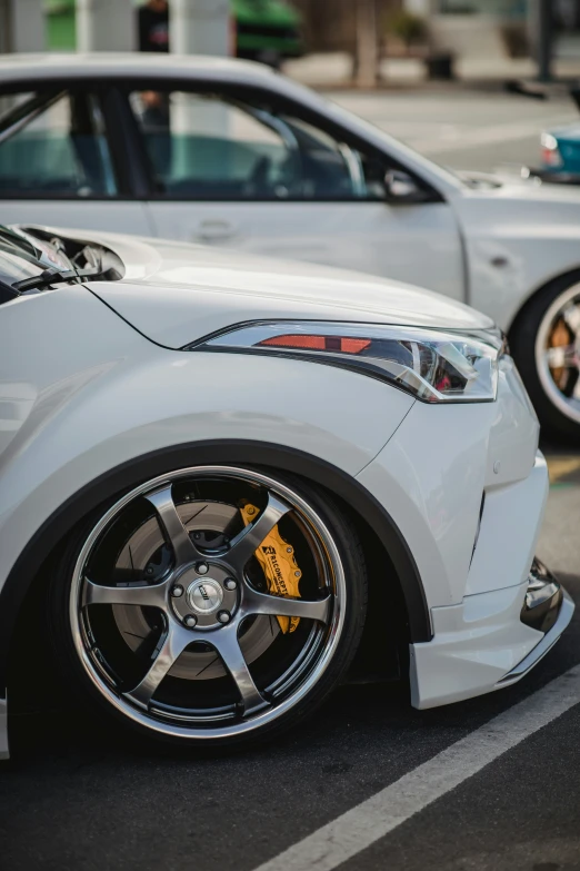 a close up s of two cars parked in a parking lot