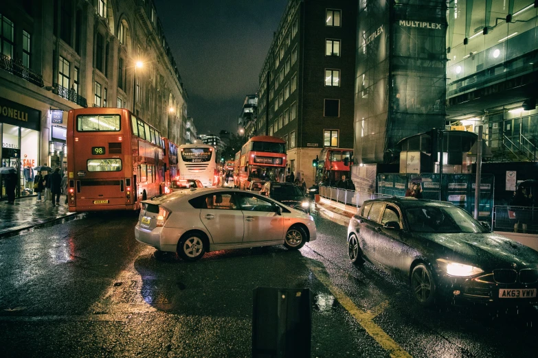 a white car driving on a street in the rain