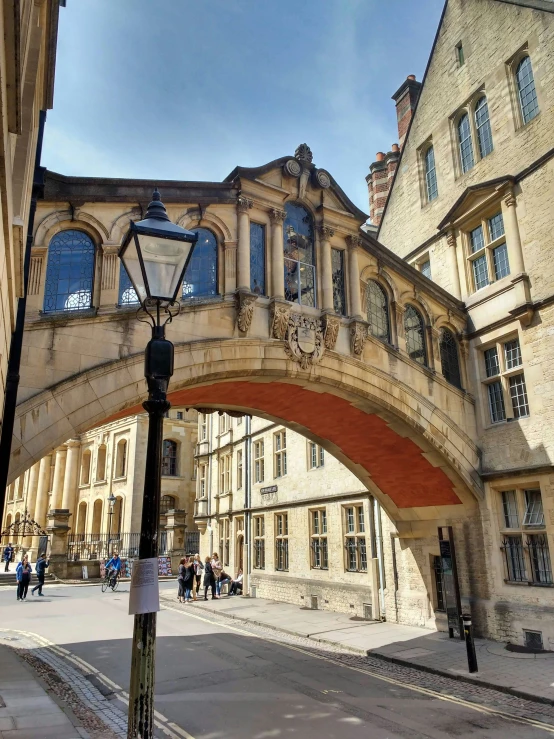 an old building has a red stone arch over it