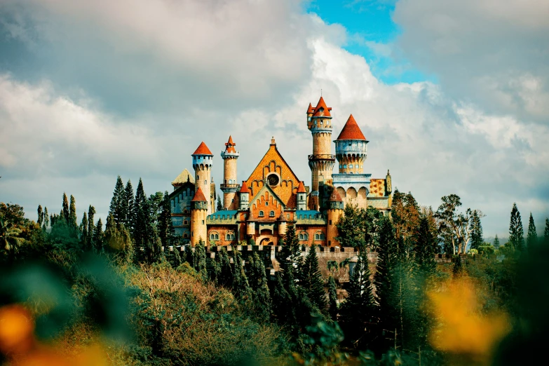 a house with towers in the forest near some bushes