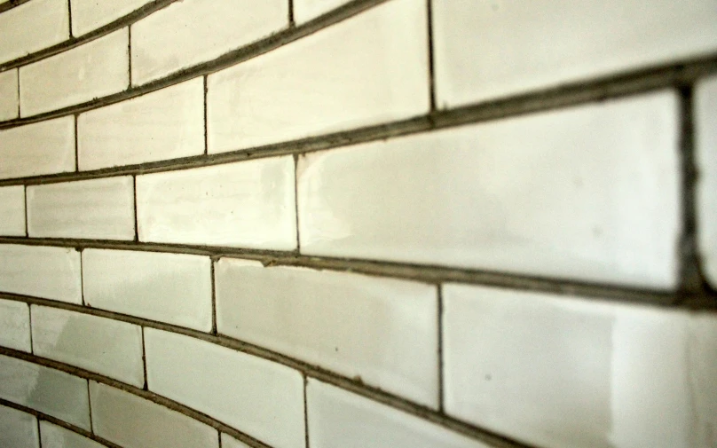 a wall of white and brown tiles and an orange object