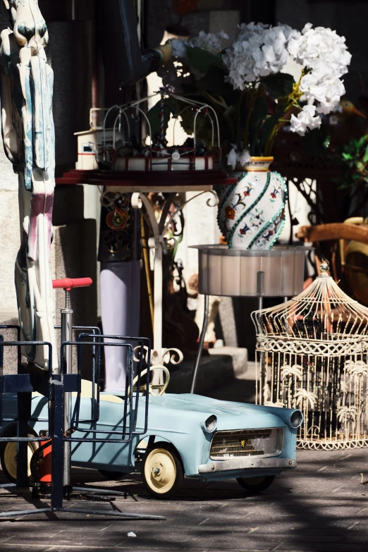 the toy is parked near some flowers and other things