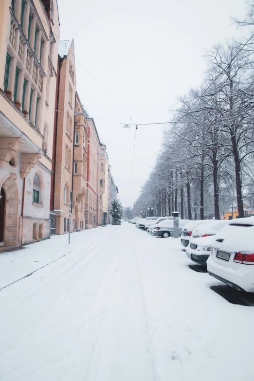 many parked cars sitting in front of a building