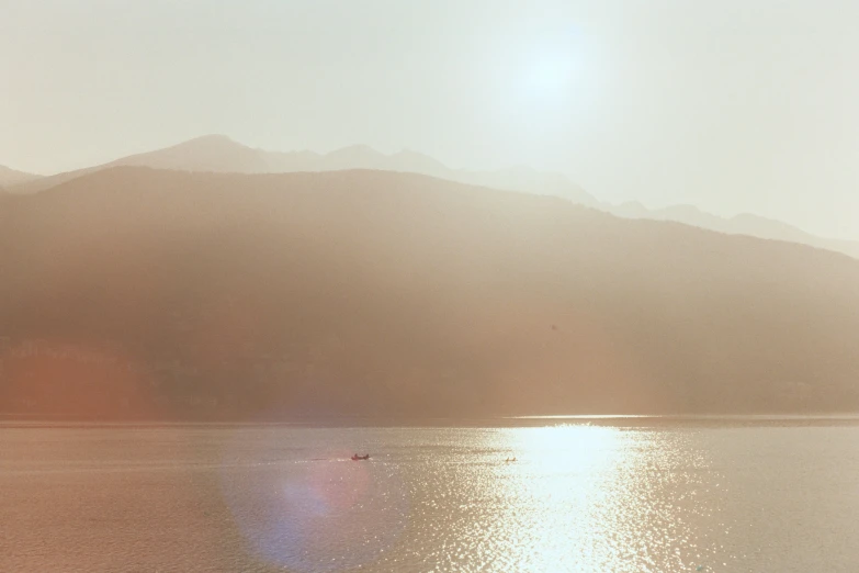 a boat that is in the water with mountains