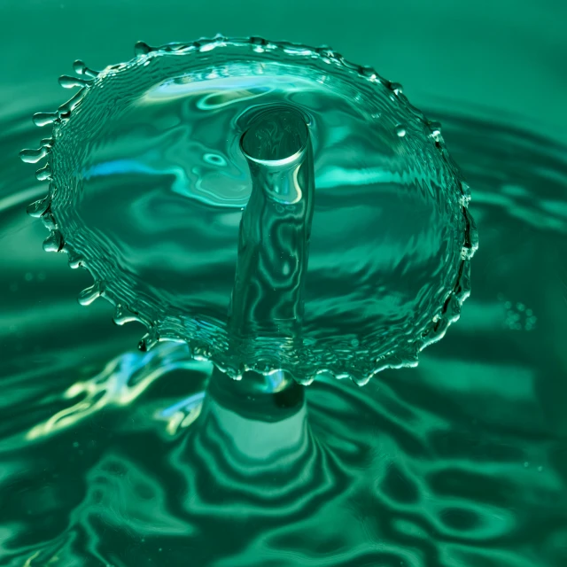 an image of a water droplet being displayed with its reflection