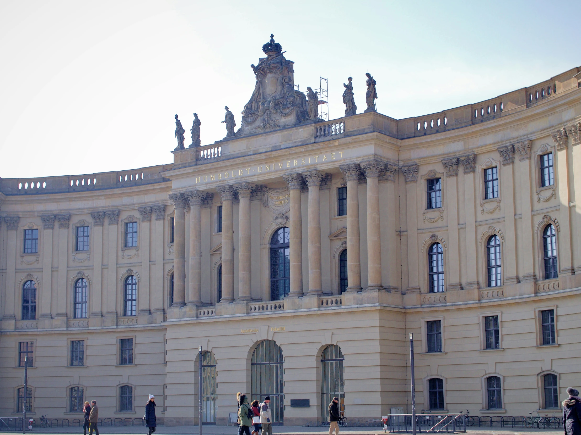 a large building with a group of people outside it