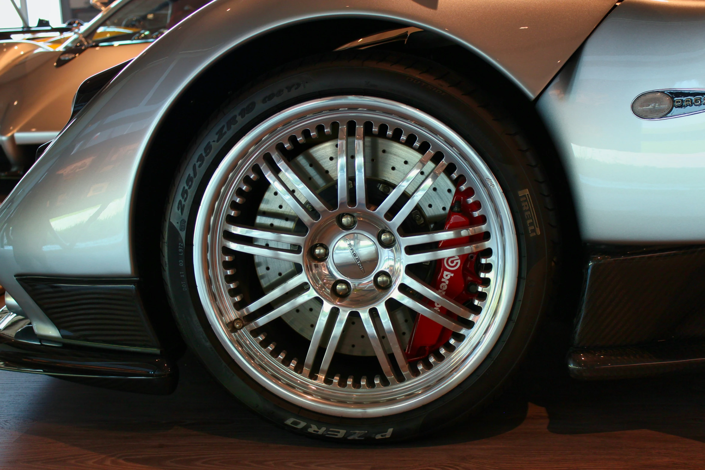 the front tire of a sports car on display at a vehicle show