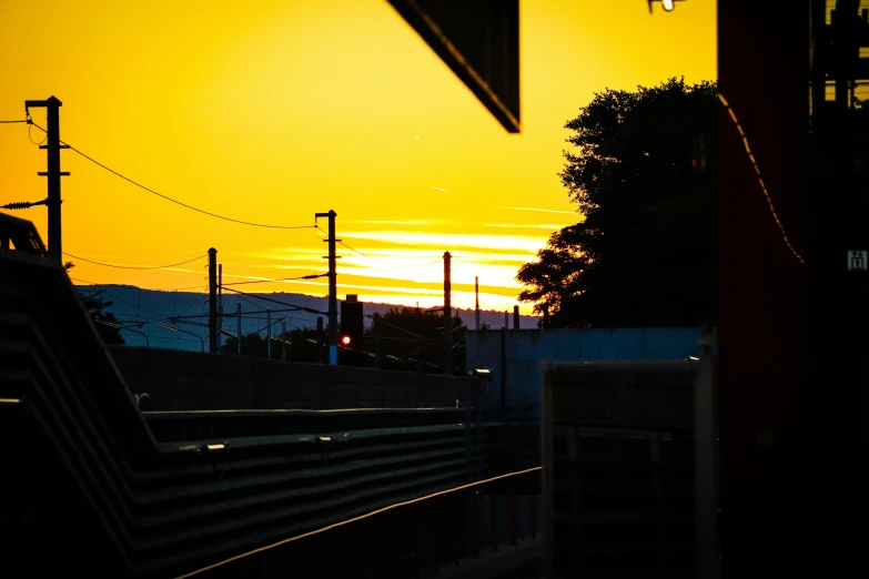 a picture of the sun setting on some kind of hills