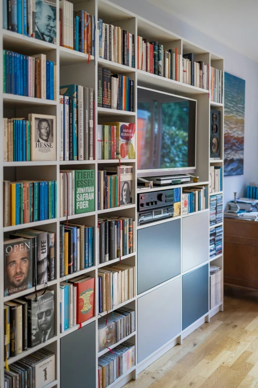 a white book case with a television on top