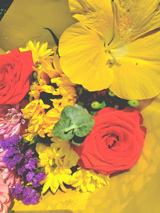 a flower bouquet in multiple colors arranged on a table