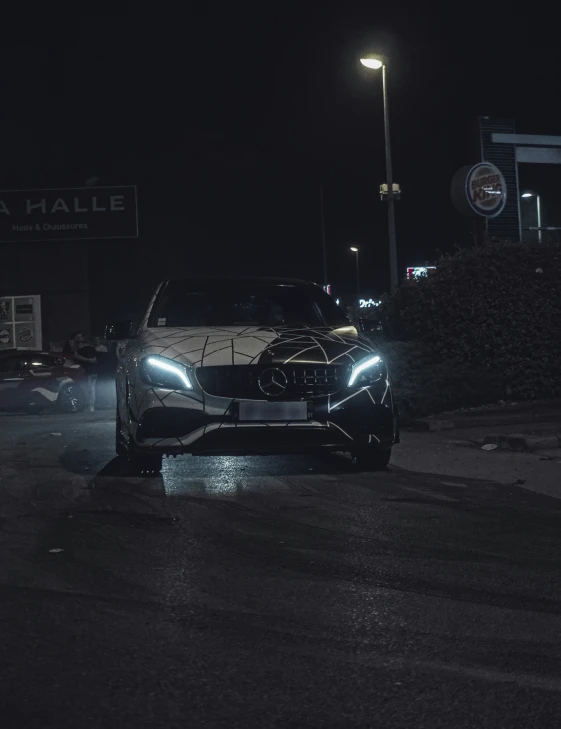 a car that is sitting in the street at night