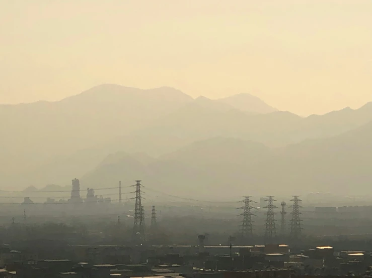 a cityscape with mountains in the background