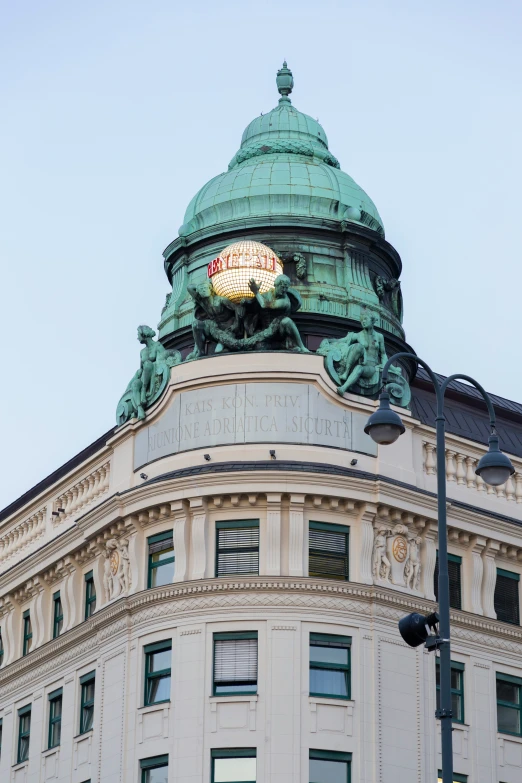 a close up of the top of a building with a large clock on it's side