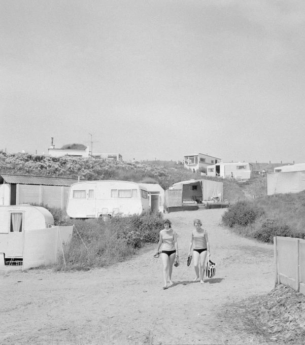 a black and white po of a couple walking their dogs