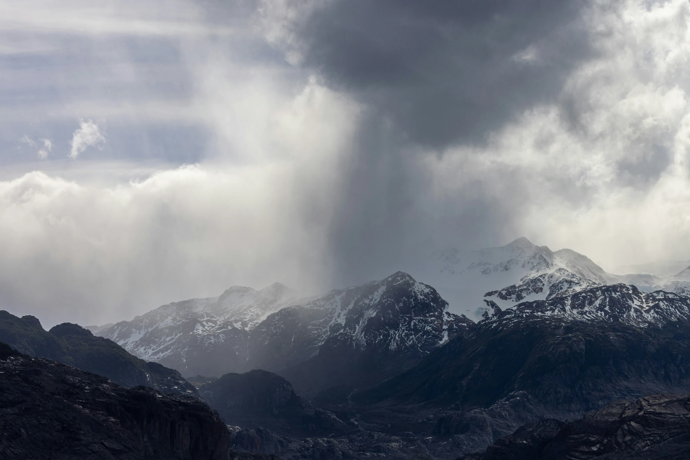 a po of a mountain range and dark clouds