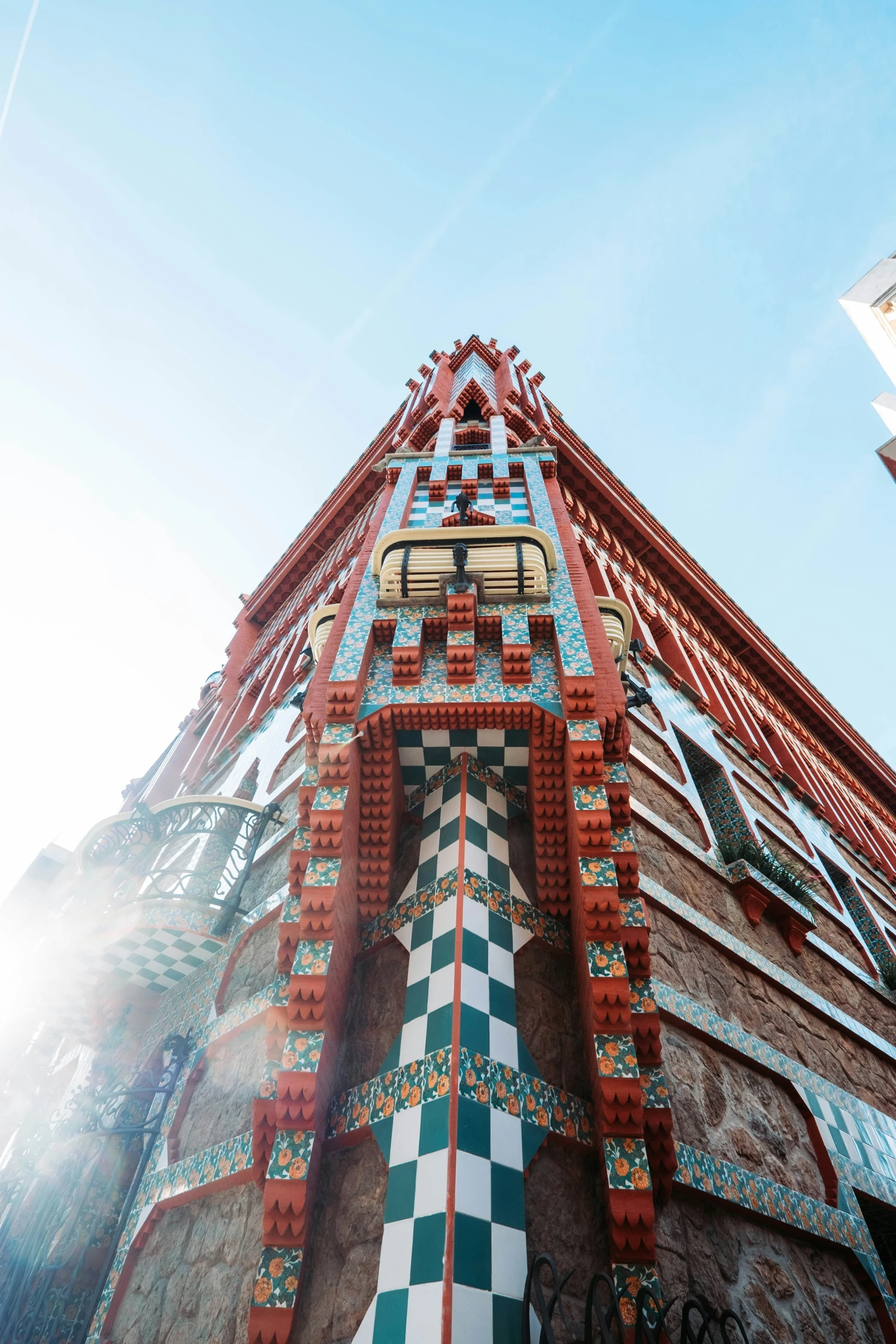 a building has a checkered tile and gold clock