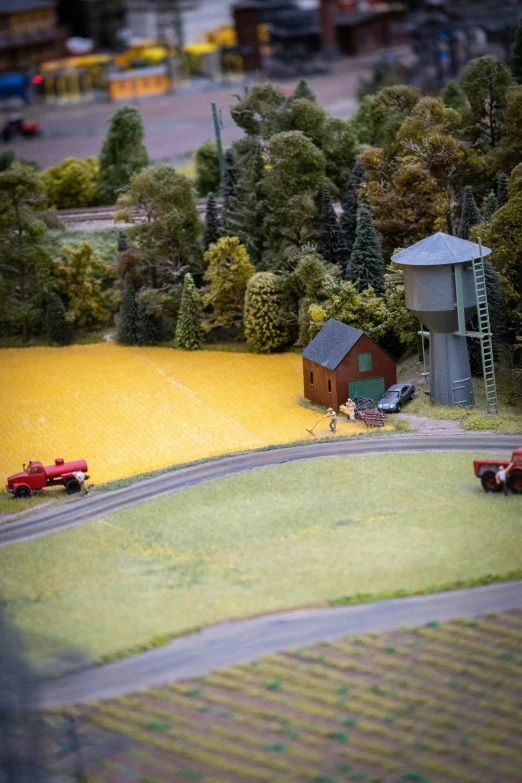 a toy train set with two trains and houses