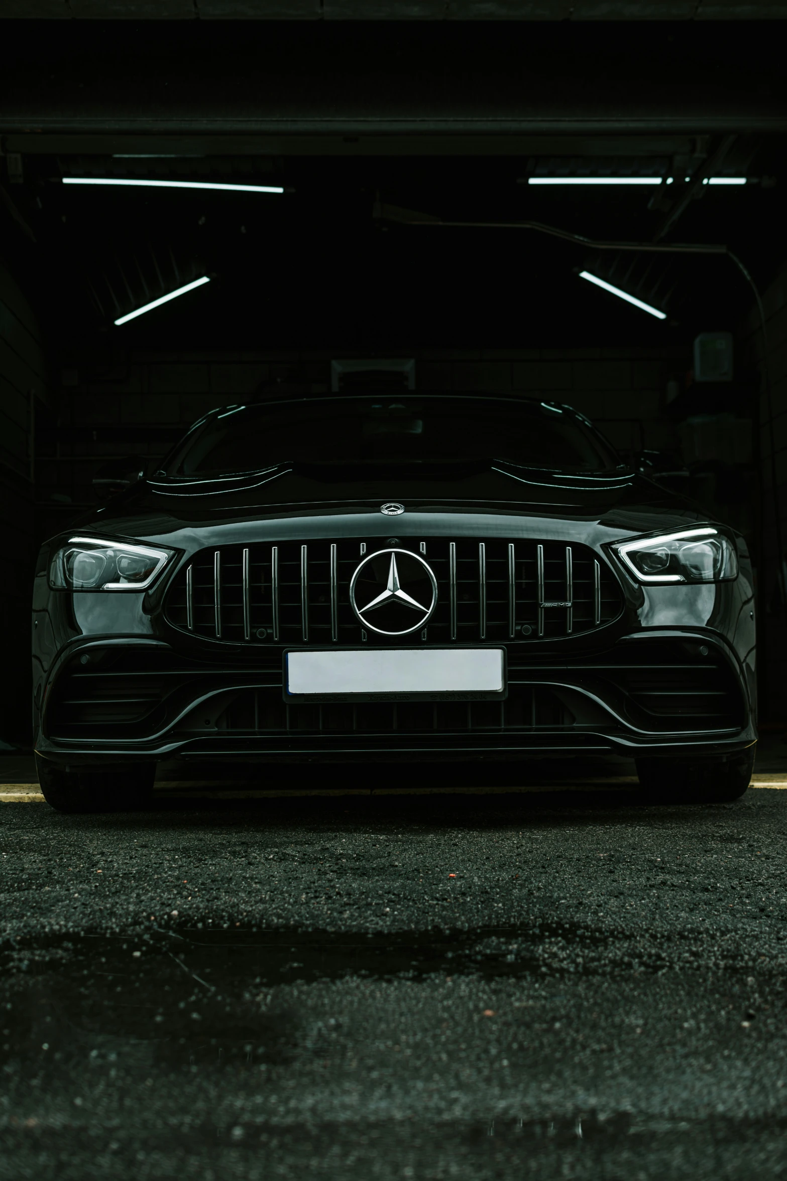 a mercedes in a parking garage at night