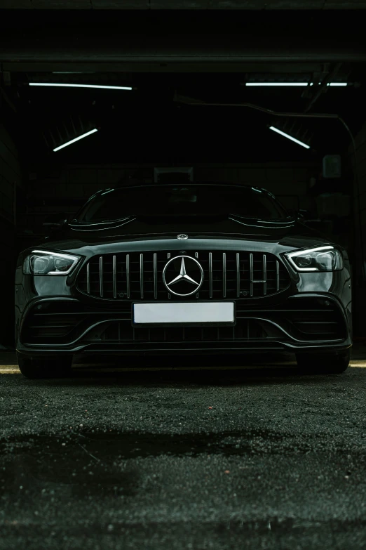 a mercedes in a parking garage at night