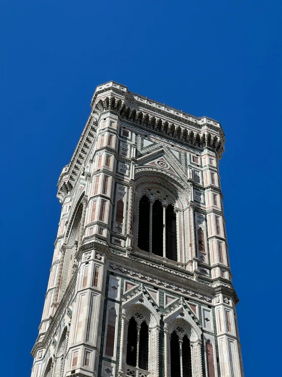 a view of a clock tower against a blue sky