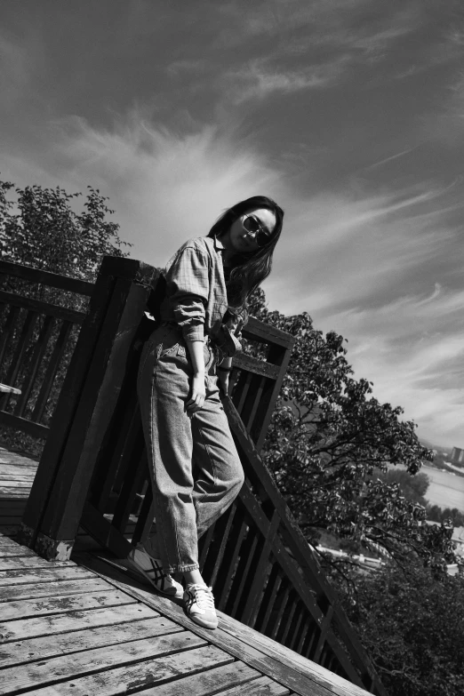 black and white po of a woman posing on a pier