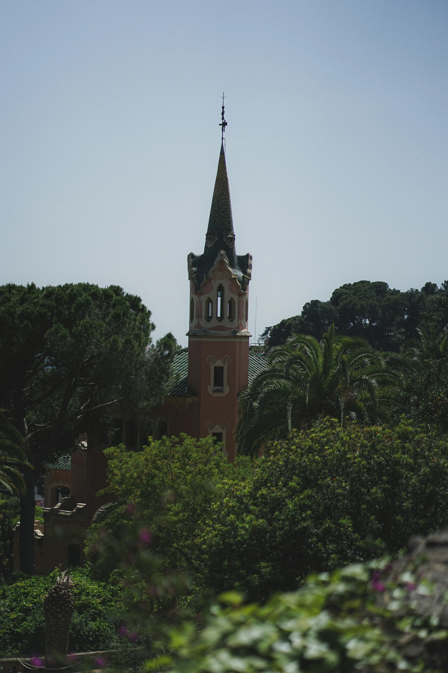 an old church tower in the trees from a distance