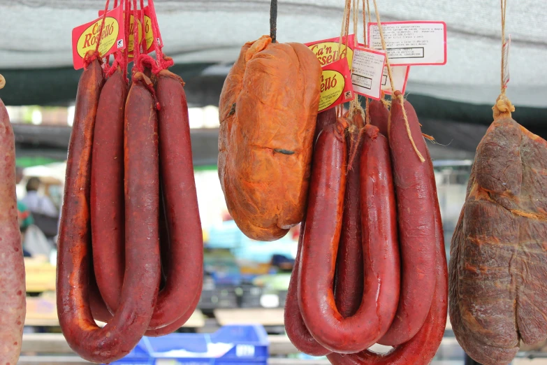 several sausages hanging from hooks for display