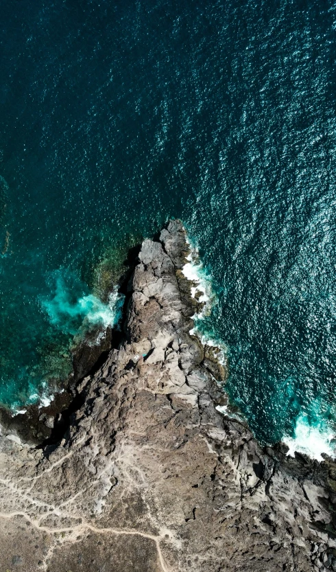 an aerial view of the water and land