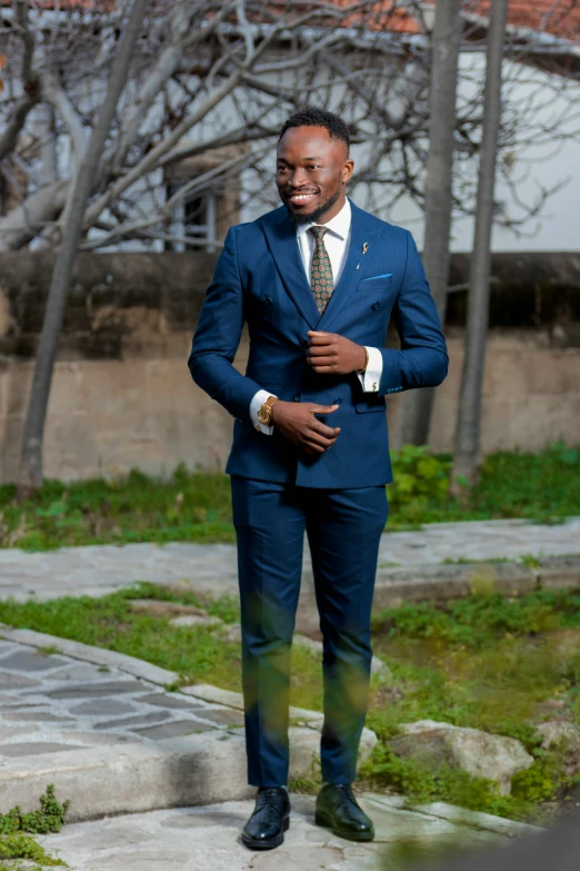 the man in a suit is standing on the sidewalk