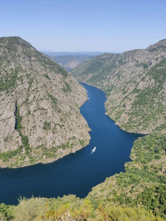 an image of a river in the middle of mountains