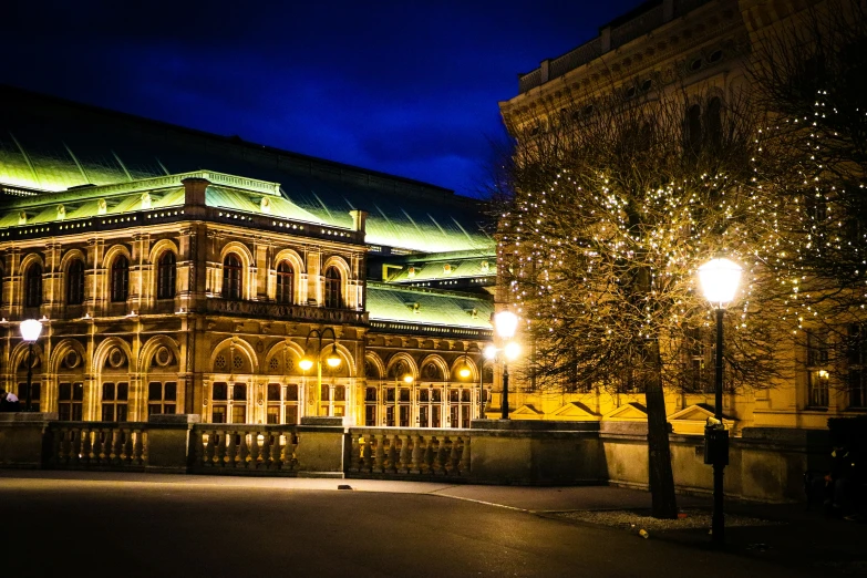 an old building lit up in green and white