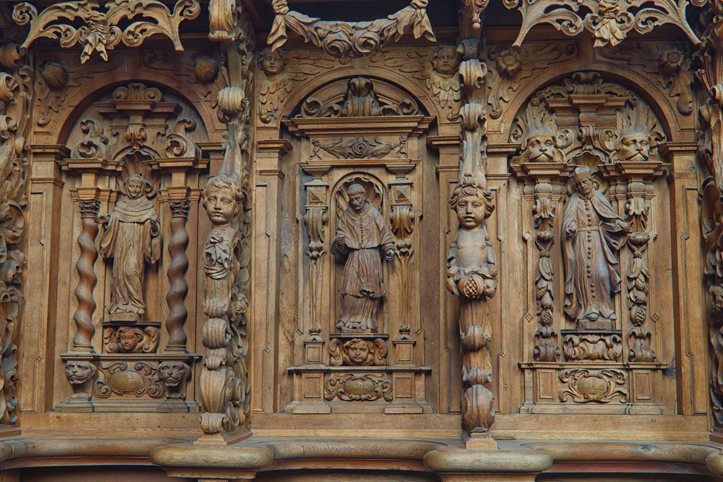 carved wooden figures and carvings on a wall