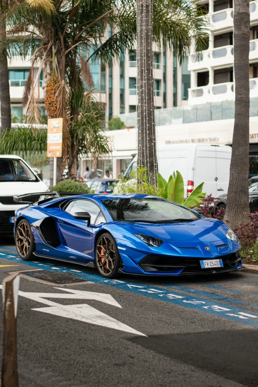 the blue car is parked in the street