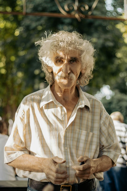 a man with graying hair wearing a white striped shirt