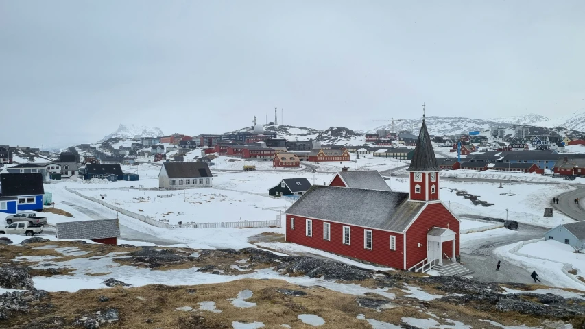 small village in the snowy countryside with snow on the ground