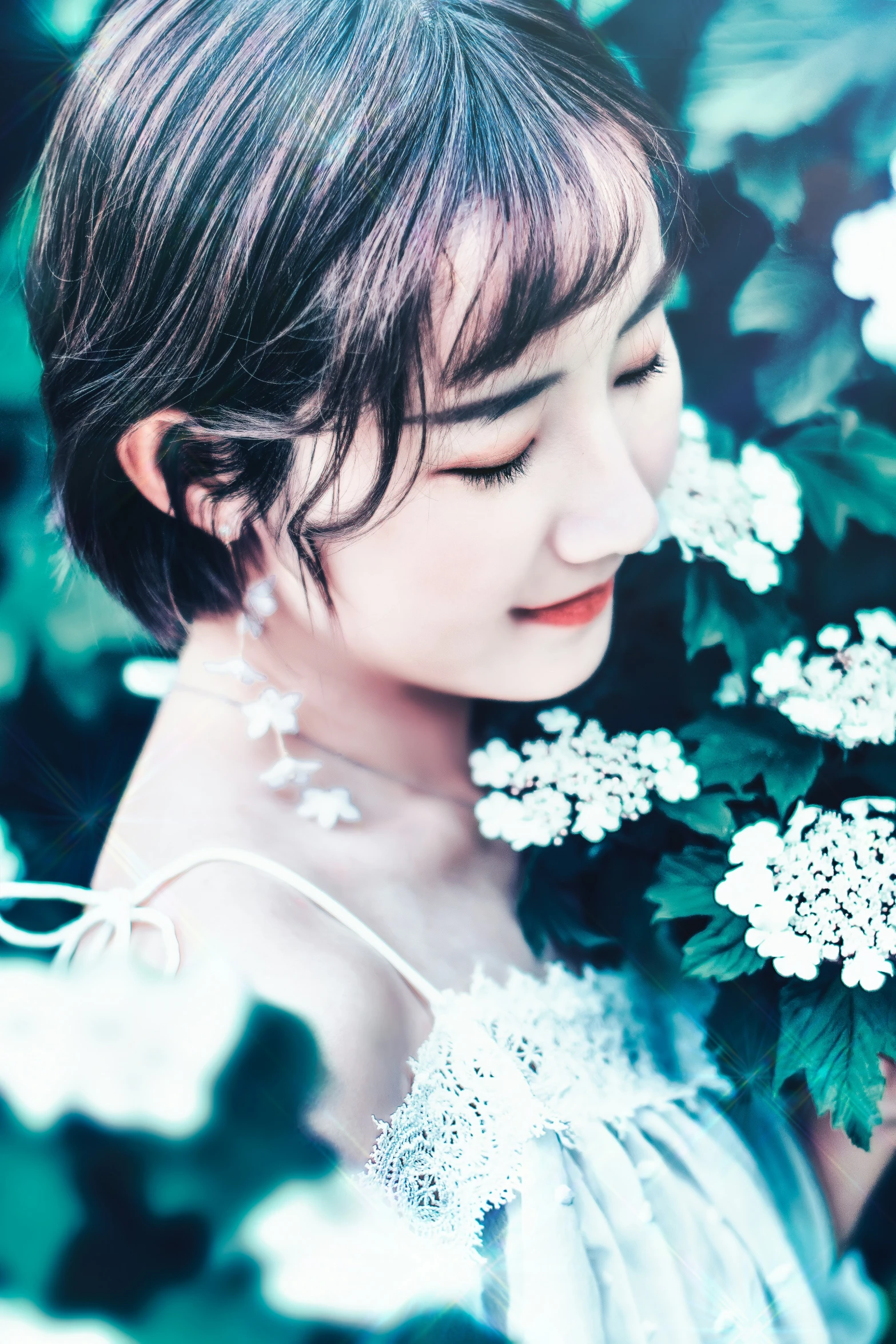 young lady wearing flower necklace looking at her bouquet