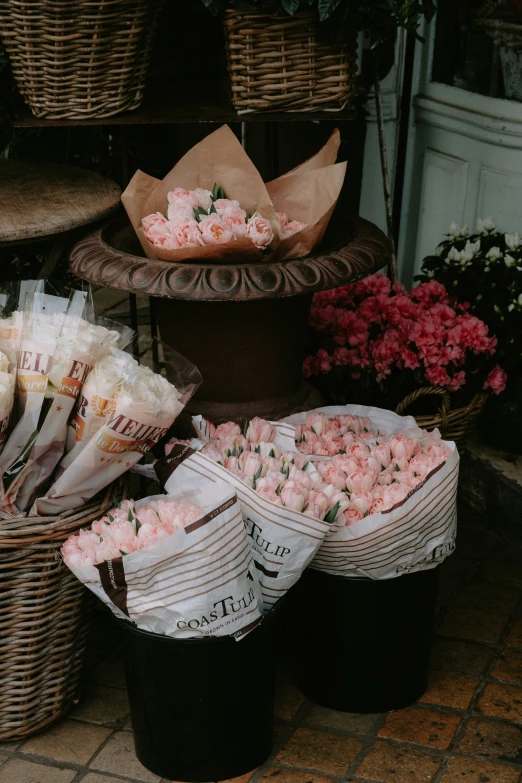 several baskets filled with flowers in front of a store