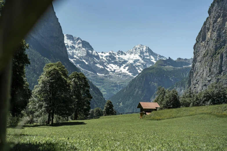 small house in the distance between two mountains