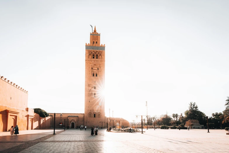 a tall building with a clock on it and people standing outside in front