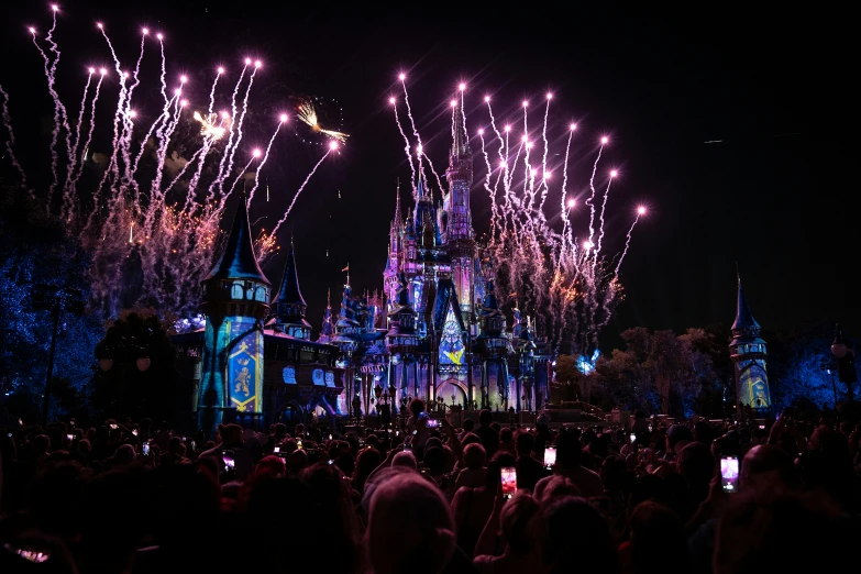 fireworks are lit up the sky above a castle