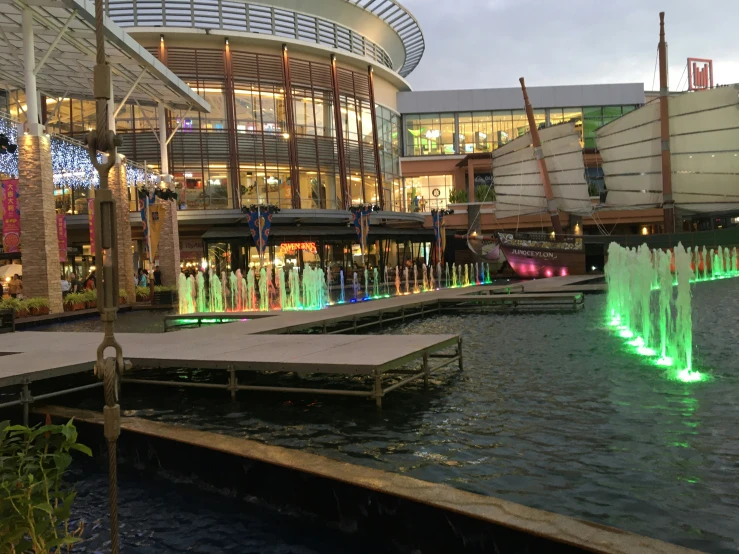 a couple of water fountains are near some buildings