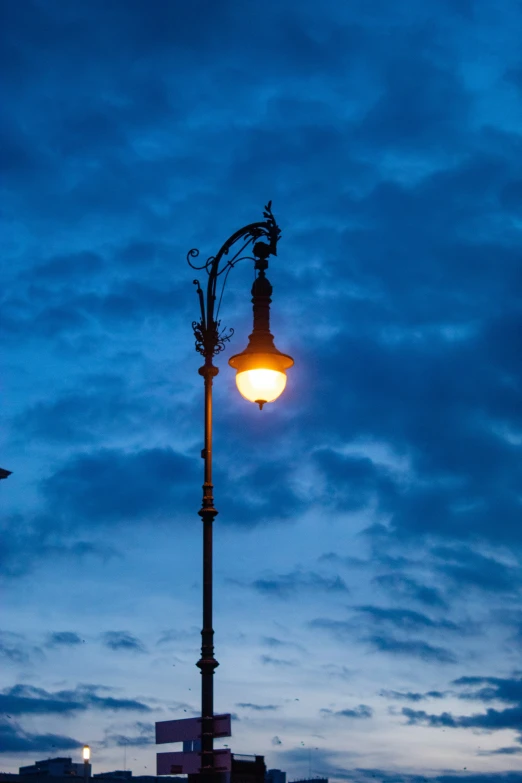 there is a street light under a very blue sky